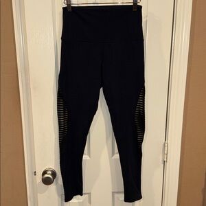 Onzie black 7/8 leggings with see-thru feature at legs. Sz M/L